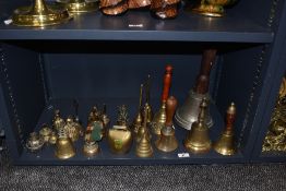 A selection of brass bells, including two cast metal church hand bells.