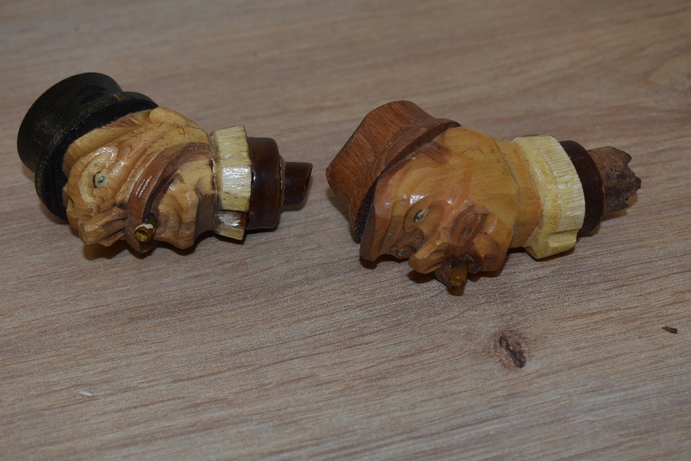 Two vintage German carved bottle stoppers.
