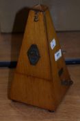 An early to mid 20th century wood cased metronome.