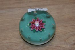 A Paul Ysart glass lamp-work paperweight, having a central lamp-worked flower within a border of
