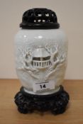 A 19th/20th century moulded glazed porcelain ginger or potpourri jar, having fretwork lid and stand,