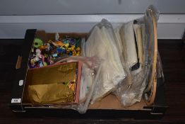 A box of needlework embroidery items, threads, frames and fabrics