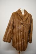 A vintage mid century caramel coloured mink coat.