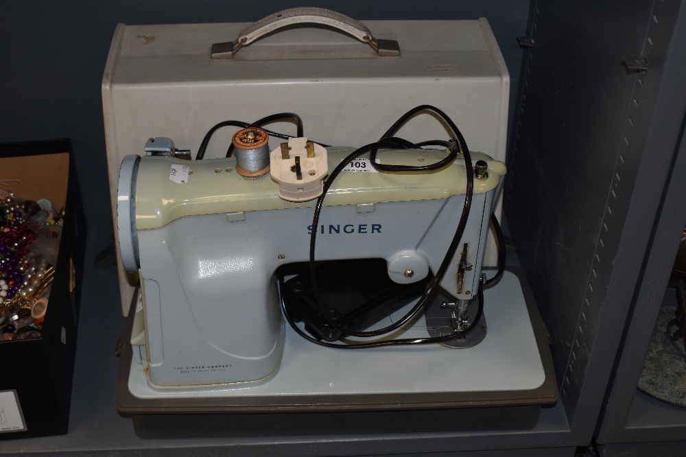 A vintage Singer sewing machine, model number 357K, with case.