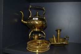 A brass spirit kettle and two brass chambersticks