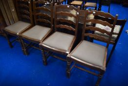 A set of four vintage stained frame ladderback dining chairs