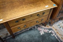 An early 20th Century golden oak coffee table or stool with two drawers under, approx. 60 x 43cm