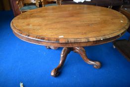 A Victorian rosewood loo table having oval tilt top on quadruple scroll base, approx. 150 x 120cm