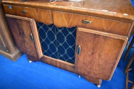 A 1950s walnut sideboard having central display section