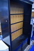 An Oriental black laquered bookcase with double cupboard under