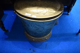 A traditional brass coal bucket