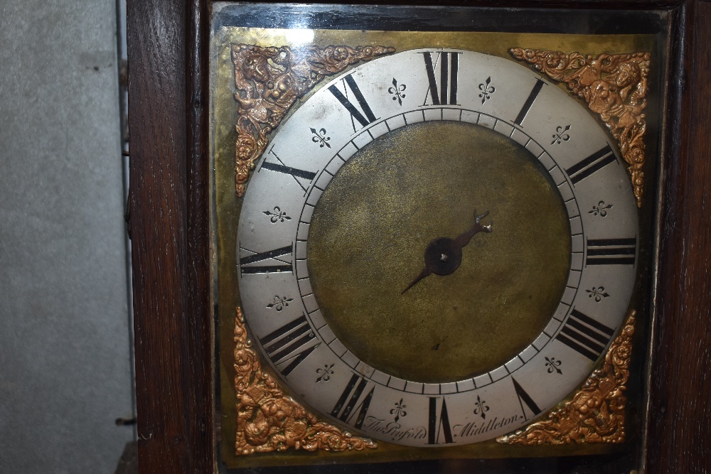 A period oak long case clock in the coffin style with single handed brass dial