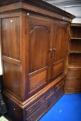 A George III oak linen press having double panelled doors over drawer base , dimensions H196cm