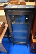 An early 20th Century oak narrow bookcase of small proportions