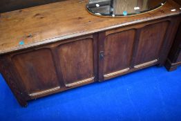 A traditional stained frame bedding chest , having lift lid and panelled doors to front