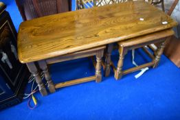 A modern mid stain Ercol coffee table nest