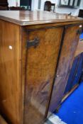 An early 20th Century walnut bedroom cabinet