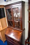 A reproduction Regency mahogany bureau bookcase
