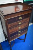 A late 19th or early 20th Century mahogany music cabinet