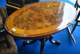 A reproduction oval occasional table, loo form