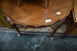 An early 20th Century low occasional table on Queen Anne style legs