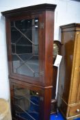 A late 19th/early 20th Century mahogany double height corner display cabinet