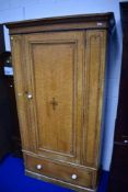 A Victorian scumbled pine single wardrobe, having drawer base