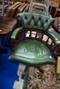 A reproduction green leather captains chair