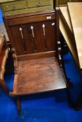 A pitch pine solid seat chair in the ecclesiastical style