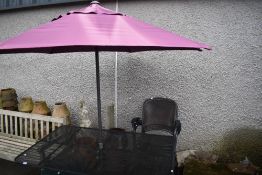 A modern metal garden table, 4 chairs and parasol