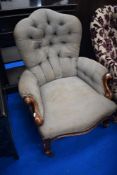 A Victorian easy chair having mahogany knurl frame and button back