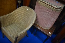 A Lloyd Loom tub chair, linen basket and period style nest of three tables
