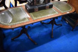 A reproduction Regency part leather topped coffee table
