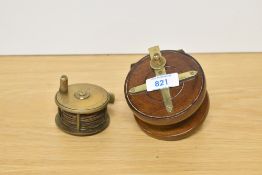 Two vintage fishing reels in lovely condition one wood and brass and the other a small brass