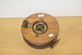 A Large wood and brass fishing reel 23cm diameter