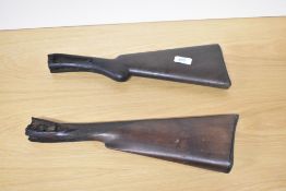 Two shotgun stocks with workings removed