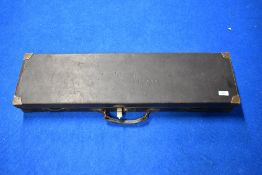 A hard Leather gun case with brass corners embossed E M ELLAND measuring 83cm x 23cm x 9cm