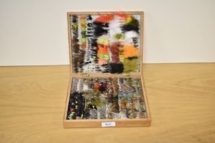 A wooden box containing approximately 600 hand tied flys and Lures doubles and winged trout