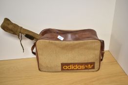 A retro Adidas sports bag containing gun cleaning kit and scope cartridge belt