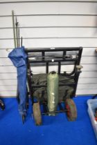A metal framed fishing trolley with pneumatic tyres and a small oakwood carp tent