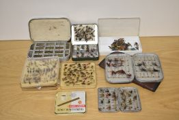 A large collection of salmon and trout flies in a variety of pocket size boxes and a wallet