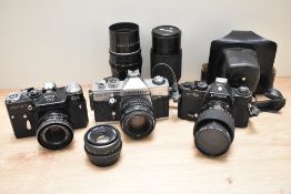 Three cameras and lenses. A Zenit EM Moshva 80 Olympic with Carl Zeiss Jana Tessar 2,8/50 lens, A