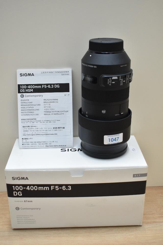 A boxed as new Sigma 100-400mm 1:5-6,3 lens