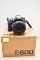 A Nikon D600 digital camera with AF-S Nikkor 24-85mm 1:3,5-4,5G lens, boxed with battery and