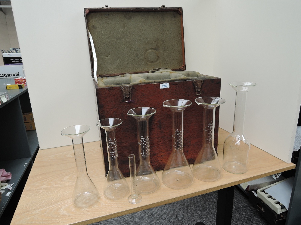 Six large glass Measures and one small glass Measure, 5ml-1 litre, decanter style in wooden travel
