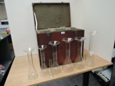 Six large glass Measures and one small glass Measure, 5ml-1 litre, decanter style in wooden travel