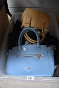 Two handbags, one of blue PVC by David Jones and the other Beige leather by Tiganello, both appear