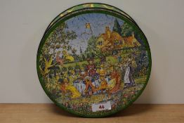 A vintage Huntley and Palmer biscuit tin having Edwardian garden party scene, perhaps better known