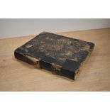 A leather bound antiquarian book, 'The English Physician Enlarged' by Culpeper.