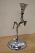 An Art Deco style chromium plated candlestick, depicting nude lady.